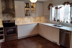 AFTER: Completely remodeled with new IKEA cabinets, SS appliances, quartz counters, and marble back splash.